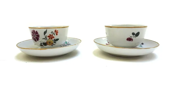 A pair of Nove porcelain teabowls and saucers, circa 1770, enamelled with flowers inside gilt-line rims, with painted red star mark and incised numera