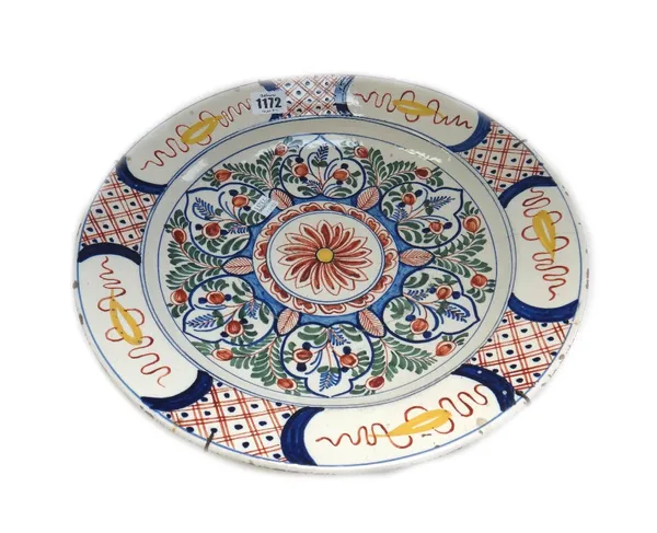 A group of Dutch Delft polychrome wares, 18th/19th century, comprising; a dish painted in the centre with flowers and leaves around a floral  medallio