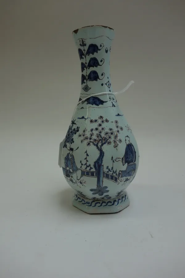 A small Dutch Delft vase, circa 1700, of octagonal pear shape, painted in Chinese transitional style in blue and manganese with figures in a landscape