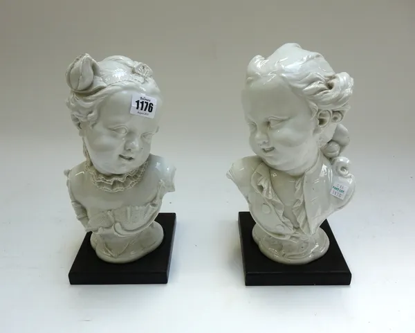 A pair of Nymphenburg white glazed busts of children, 20th century, after 18th century models by F.A.Bustelli, with impressed shield marks and blue pa