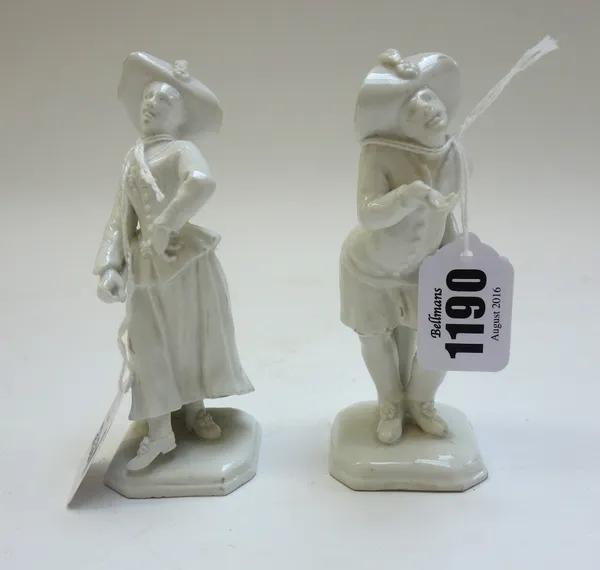A pair of Vienna white glazed figures of begging Harlequin and Columbine, circa 1744-50, with impressed shield and 'D' marks at the back, in plumed ha