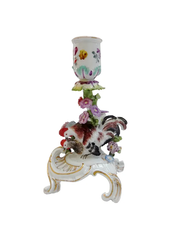 A Meissen flower encrusted candlestick, circa 1755, with blue crossed swords mark, modelled with a cockerel and hen atop a C scroll base, 14.5cm high.