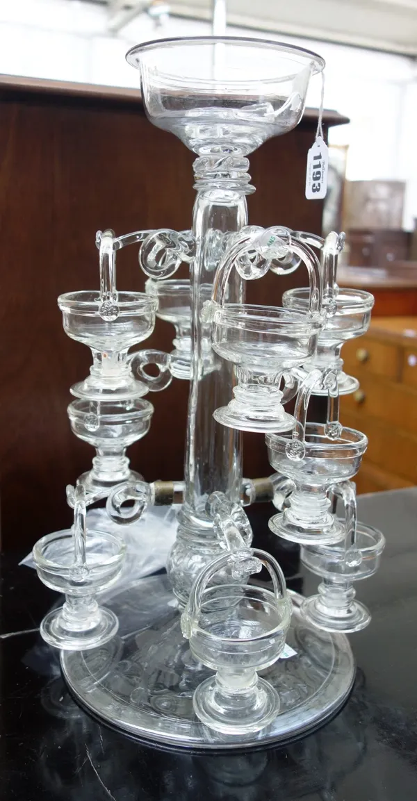 A glass sweetmeat centrepiece of tiered circular form, 19th century, the central stem issuing nine arms, each holding a glass cup with a loop handle (