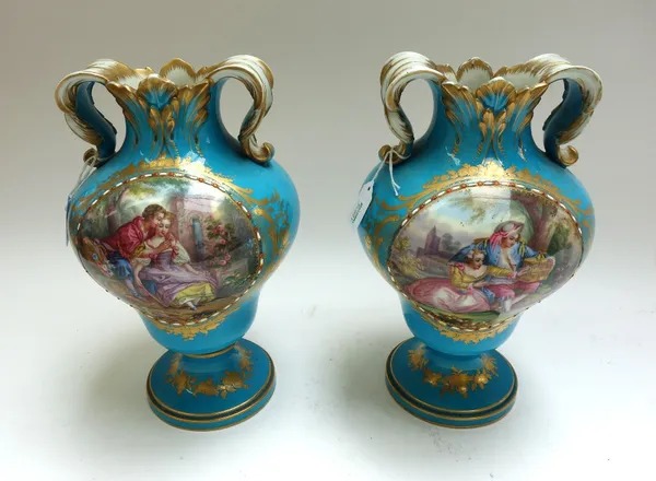 A pair of Sevres style bleu celeste ground two handled vases, circa 1870, with gilt interlaced  'L' marks, after the Sevres vase d'orielles, painted t