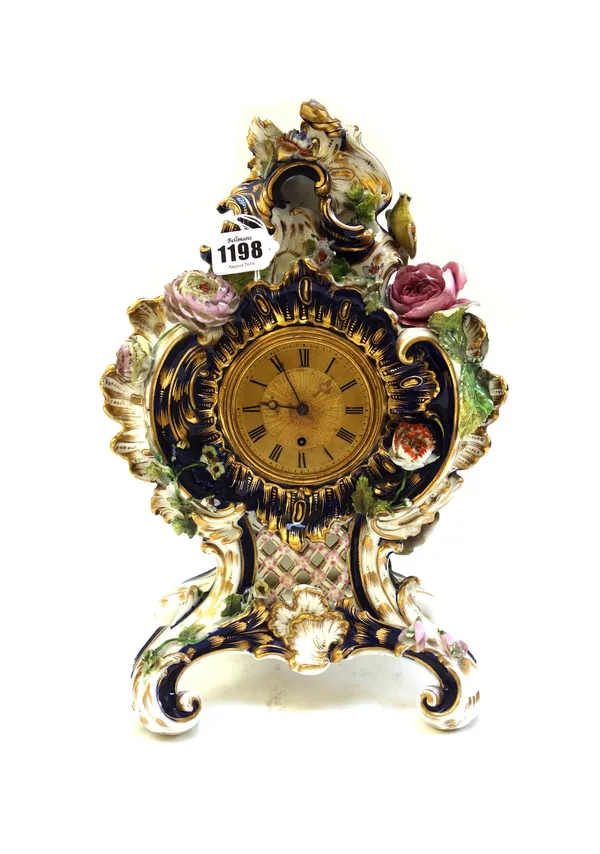 A porcelain mantel clock, possibly Coalport, circa 1830, decorated with applied fauna and flora, 34cm high.