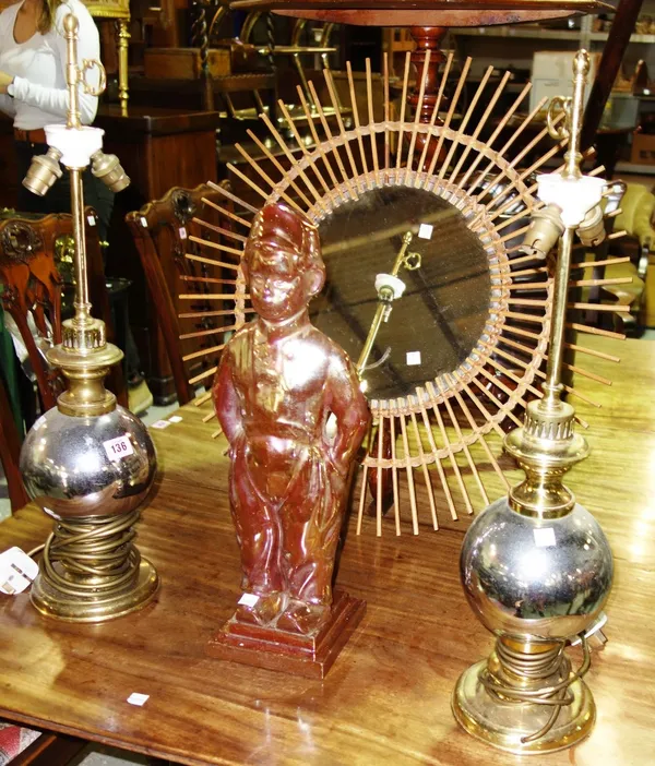 A pair of steel and brass table lamps, a circular mirror and a fire stand modelled as Mr Pickwick. (3)