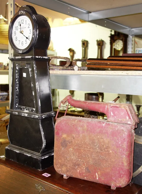 A 20th century clock in the form of a miniature longcase clock, together with a large metal candlestick and an early 20th century petrol can, (3).