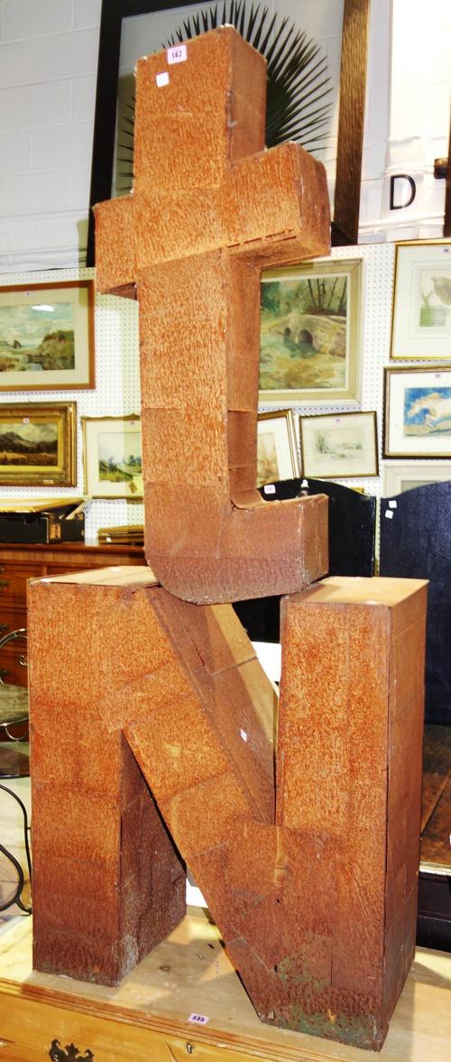 A pair of large iron three dimensional letters; 'T' and 'N'. (2)