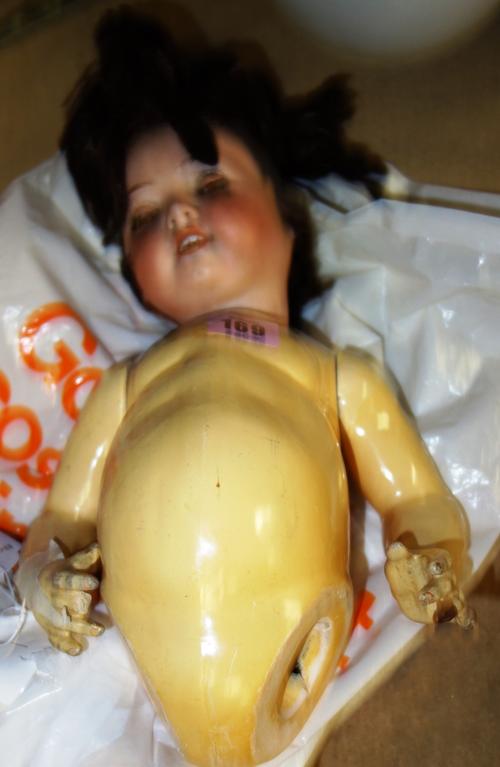 A German bisque headed doll, the head with open mouth, sleeping eyes and marked 3213 Germany, on disassembled jointed body.