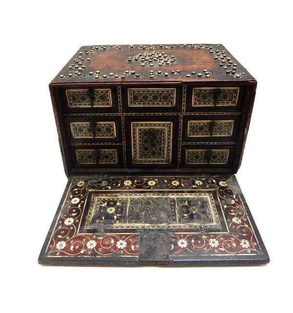 A 17th/18th century Indian mother of pearl inlaid table cabinet, the drop front revealing a parquetry inlaid bone interior of six various drawers, 29c