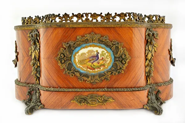 A 19th century French gilt metal and ceramic mounted kingwood jardiniere of serpentine outline, 50cm wide.  Illustrated