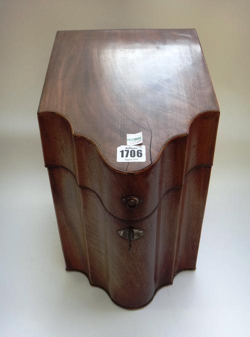 A George III mahogany slope front knife box, with serpentine lid and original fitted interior, 23cm wide.