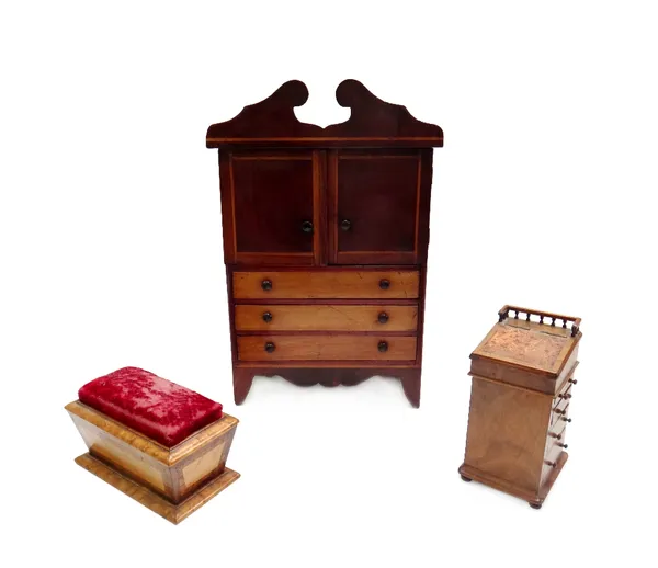A miniature mahogany linen press, with fitted interior, 27cm wide x 40cm high, together with a miniature walnut slide top Davenport, 8cm wide x 17cm h