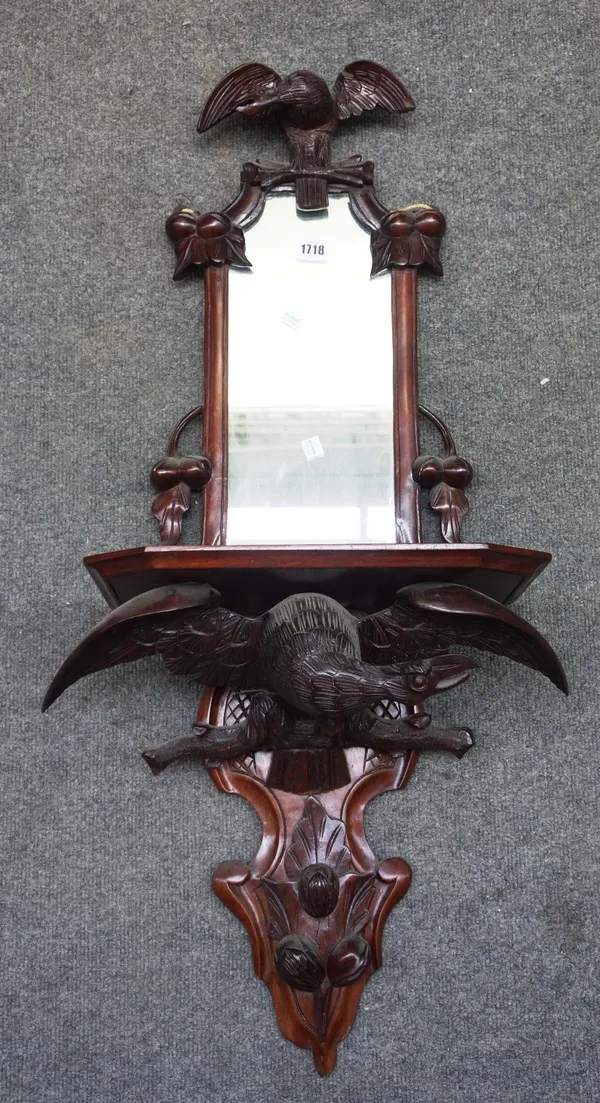 A 19th century Black Forest carved wood hall mirror, with bird crest and lower frieze, 94cm high x 45cm wide.