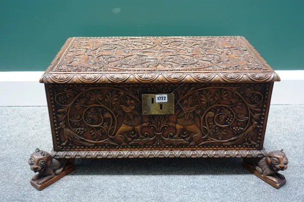 A 19th century Indo-Portuguese hardwood casket, profusely carved with beasts on a foliate background, on four beast supports, 76cm wide.