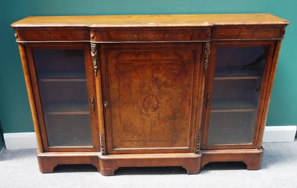 A Victorian inlaid figured walnut breakfront credenza, with panel central door flanked by glazed cupboards, on bracket feet, 168cm wide.