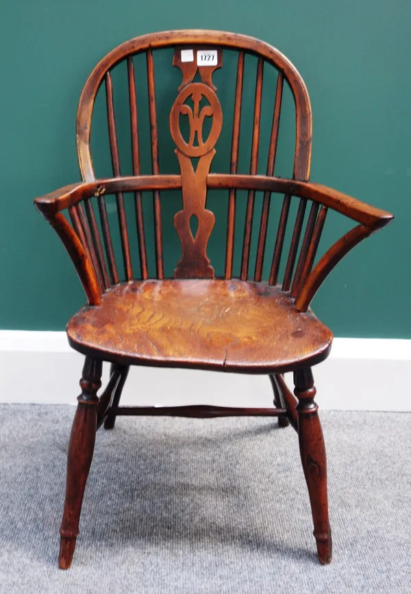 A George III yew and elm child's Windsor chair, with Prince of Wales carved splat and solid seat, on turned supports.