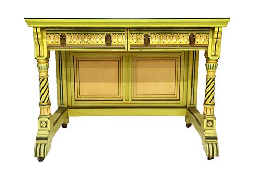 A green painted Gothic Revival side table, with pair of frieze drawers on turned supports, united by panel back board, 107cm wide.  Illustrated