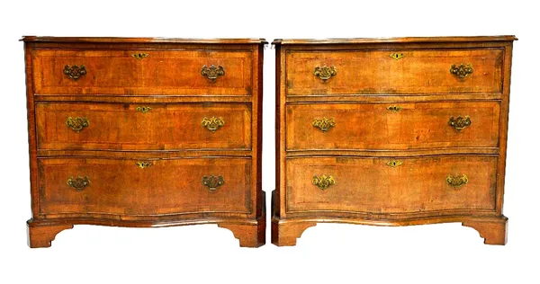 A pair of mid 18th century style serpentine walnut chests of three long graduated drawers, on bracket feet, 93cm wide.  Illustrated