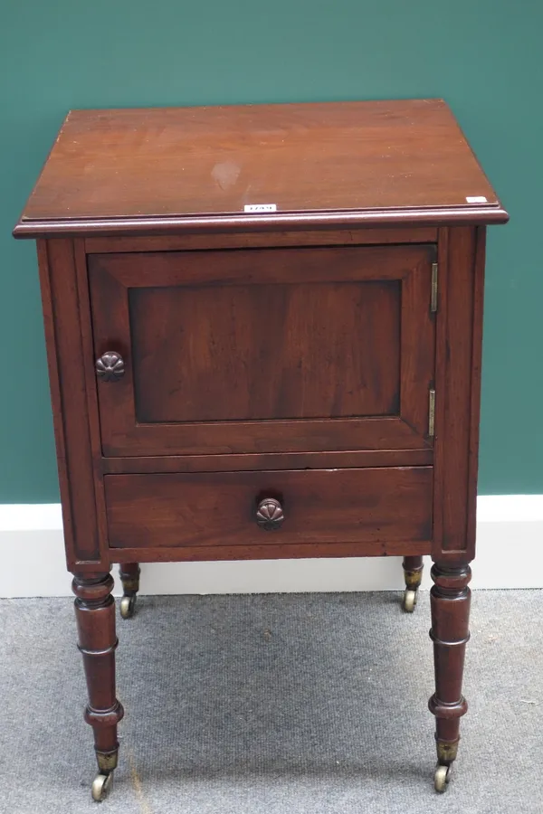 A William IV mahogany bedside cabinet, with panel door over drawer, on turned supports, 50cm wide.
