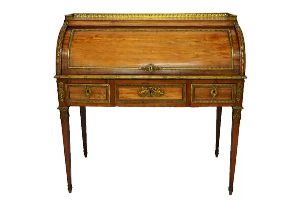 A Louis XVI style ormolu mounted rosewood cylinder bureau, with pull-out fitted interior, over three frieze drawers on tapering square supports, 100cm