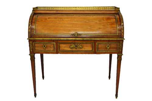 A Louis XVI style ormolu mounted rosewood cylinder bureau, with pull-out fitted interior, over three frieze drawers on tapering square supports, 100cm