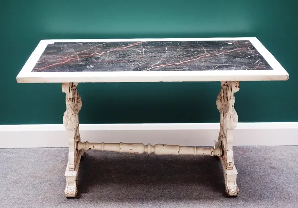 An early 19th century centre table, the rectangular marble top on white painted pierced and carved trestle end standards, united by turned stretcher,