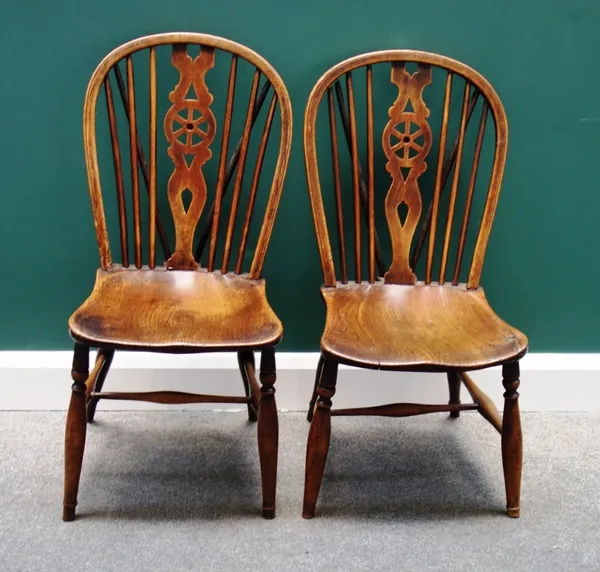 A set of four 19th century ash and elm wheel back chairs, on turned supports, stamped 'TB', 'TB', 'W. LOW' and 'BF'. (4)