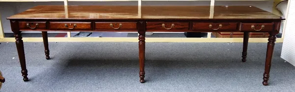 A 19th century mahogany preparation table, the rectangular top over six frieze drawers, on six turned tapering supports, 84cm wide x 282cm long.