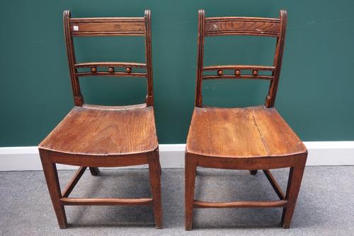 A set of six George III oak and elm dining chairs, with ball mounted waist rail and dished solid seat, on tapering square supports, (6).
