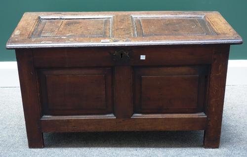 A small 17th century oak coffer, with double panel lid and front, on stile feet, 91cm wide.    Item 53