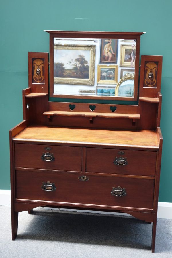 Shapland and Petter; an Art Nouveau inlaid mahogany dressing chest, with bevelled swing mirror over two short and one long drawer, 108cm wide.