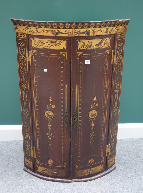 A George III (later Aesthetic Movement painted) mahogany bowfront hanging corner cabinet, 70cm wide.