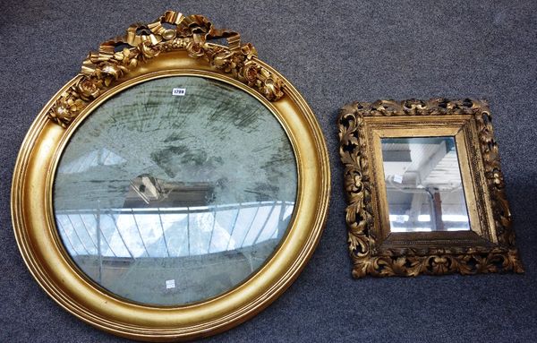 A 19th century gilt framed circular convex wall mirror, with ribbon tied floral crest, 73cm wide x 82cm high, together with a small gilt framed wall m