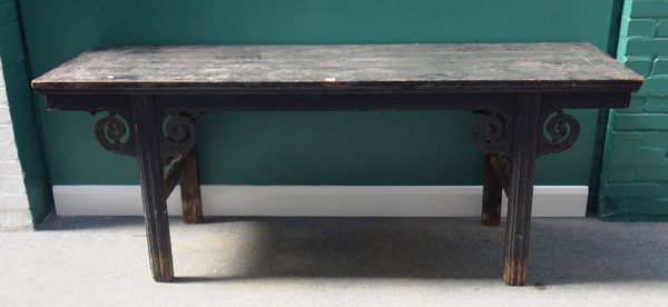 A late 19th century Chinese ebonised altar table, on block supports, mounted with pierced scroll brackets, 205cm wide.