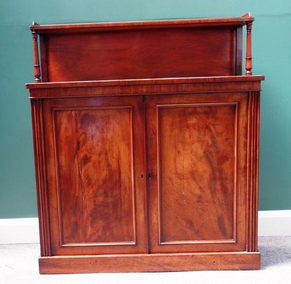 An early 19th century mahogany chiffonier, the ledge back over a pair of panel doors, on plinth base, 107cm wide.