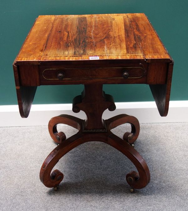 A Regency rosewood games table, the chessboard inlaid drop flap reversible top on shaped silhouette column and four inswept scroll supports, 54cm wide