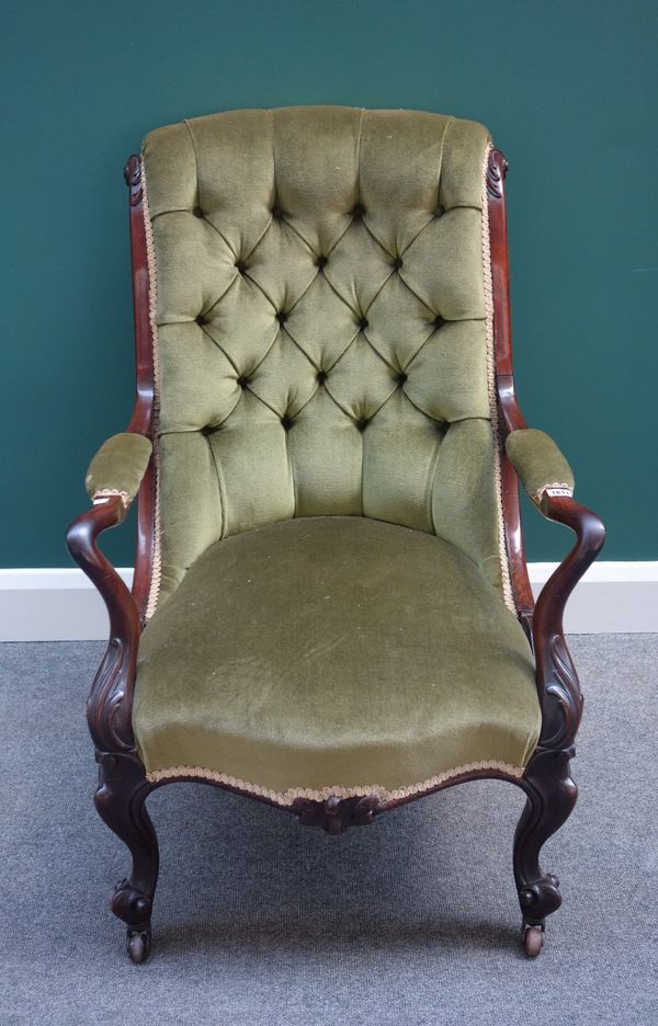 A Victorian rosewood framed open arm easy armchair, with serpentine seat on scroll supports.