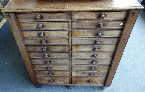 A Victorian mahogany collector's chest with two rows of ten graduated drawers, each enclosed by locking bar on turned feet, 90cm wide.