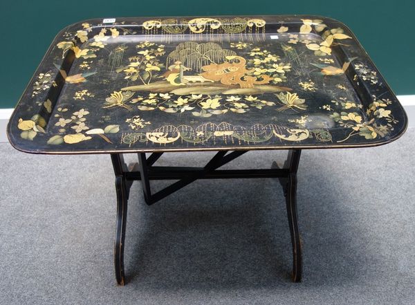 A Regency black lacquer chinoiserie decorated rectangular tray on later stand, 77cm wide, together with a burgundy and gilt pineapple decorated tray,