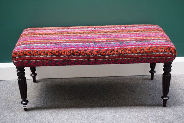 A rectangular footstool, the kelim upholstered top on four William IV mahogany supports, 103cm wide.