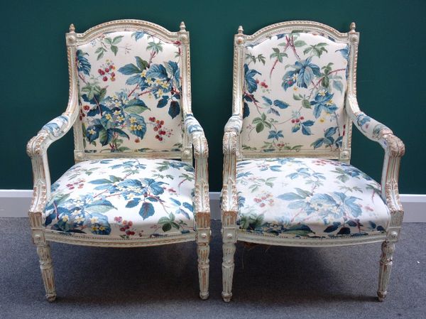 A pair of early Louis XVI style cream painted fauteuils, with bow seats, on tapering fluted supports.