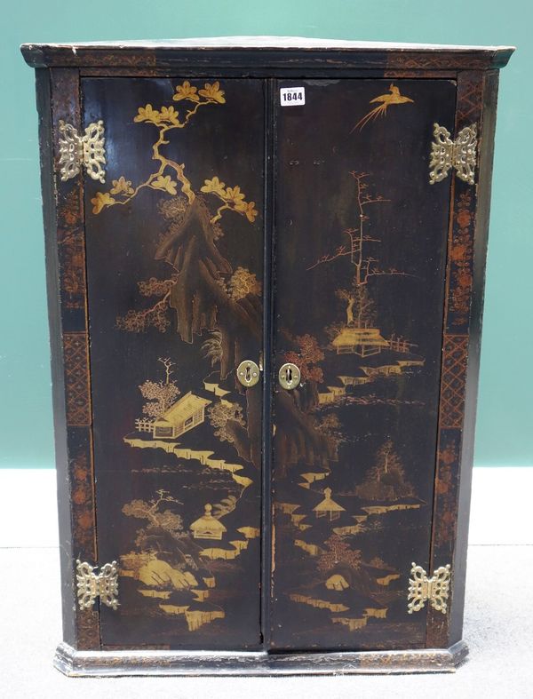 An 18th century black lacquer chinoiserie decorated hanging two door corner cupboard, 64cm wide.