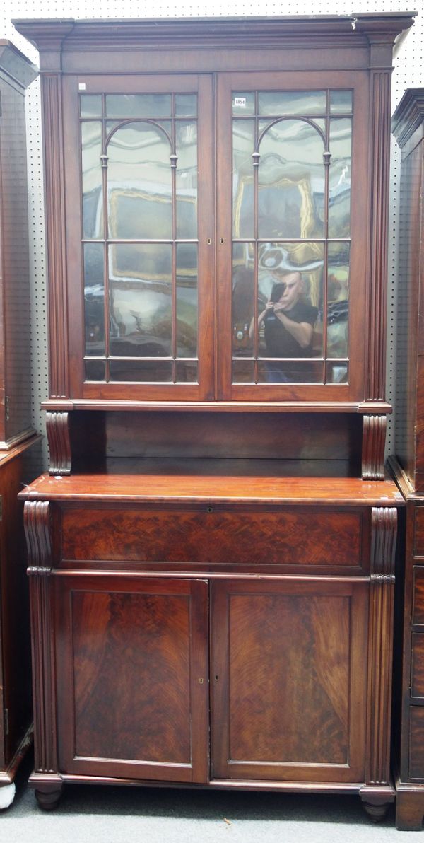 A William IV mahogany secretaire bookcase, the pair of glazed doors over a recess, a fitted drawer and pair of cupboards enclosing a fitted interior,