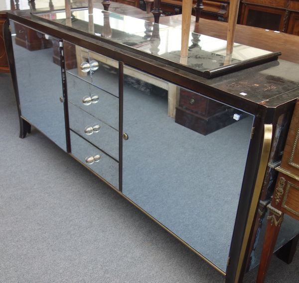 A 20th century mahogany and mirrored veneered sideboard, with four central drawers, flanked by cupboards, on splayed feet, 210cm wide,