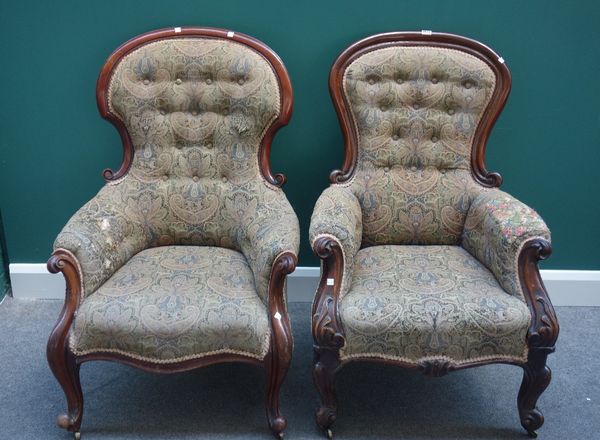 A Victorian mahogany framed spoon back easy armchair, with serpentine seat on scroll supports, together with another similar, (2).