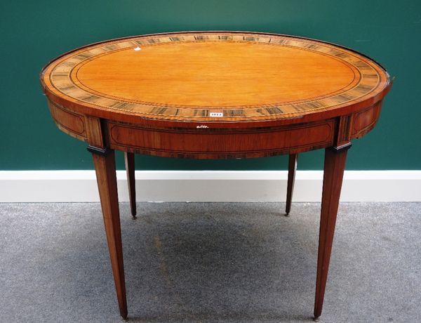 A George III coromandel banded satinwood oval writing table, on tapering square supports, 103cm wide.