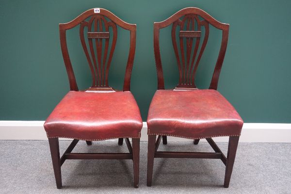 A set of four early 19th century mahogany framed shield back dining chairs, with serpentine seats, on tapering square supports. (4)