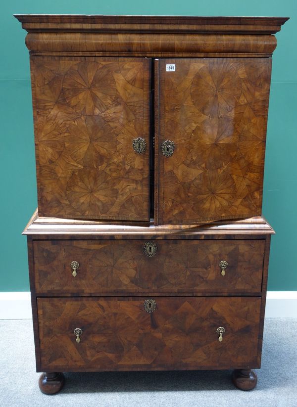 A William and Mary and later parquetry kingwood cabinet on chest, the pair of doors enclosing a fitted interior, the chest with two long drawers on bu