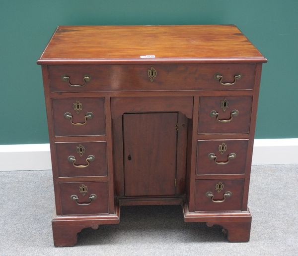 A mid 18th century mahogany kneehole desk, with eight drawers about the kneehole cupboard, on bracket feet, 79cm wide.